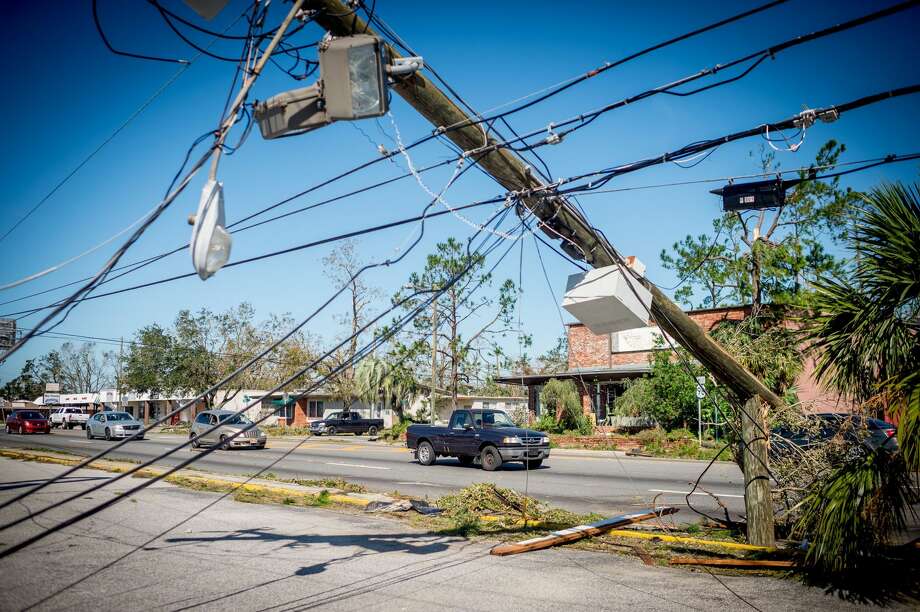 A fallen powerline is seen in front of a home in Panama City, Florida after Hurricane Michael on October 11, 2018. - Residents of the Florida Panhandle woke to scenes of devastation Thursday after Michael tore a path through the coastal region as a powerful hurricane that killed at least two people. Photo: EMILY KASK/AFP/Getty Images