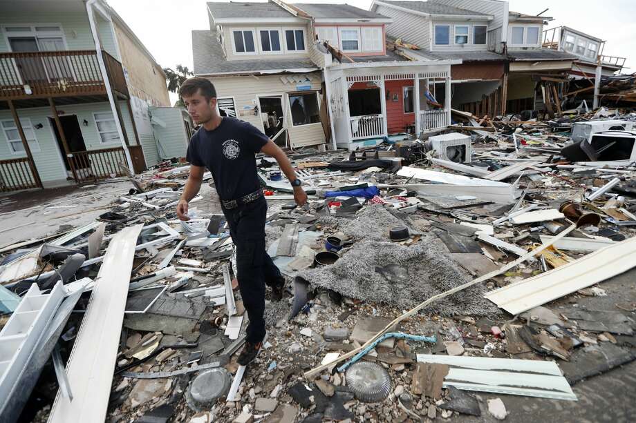 Firefighter Austin Schlarb performs a door to door search in the aftermath of Hurricane Michael in Mexico Beach, Fla., Thursday, Oct. 11, 2018. (AP Photo/Gerald Herbert) Photo: Gerald Herbert/AP