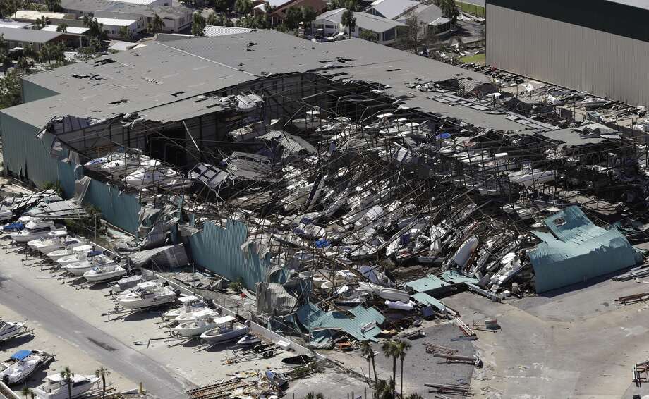 A roof over a boat storage building is collapsed following Hurricane Michael Thursday, Oct. 11, 2018, in Panama City Beach, Fla. Hurricane Michael made landfall Wednesday as a Category 4 hurricane with 155 mph (250 kph) winds and a storm surge of 9 feet (2.7 meters). (AP Photo/Chris O'Meara) Photo: Chris O'Meara/AP