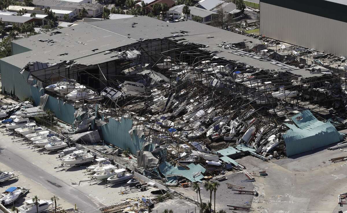 A roof over a boat storage building is collapsed following Hurricane Michael Thursday, Oct. 11, 2018, in Panama City Beach, Fla. Hurricane Michael made landfall Wednesday as a Category 4 hurricane with 155 mph (250 kph) winds and a storm surge of 9 feet (2.7 meters). (AP Photo/Chris O'Meara)