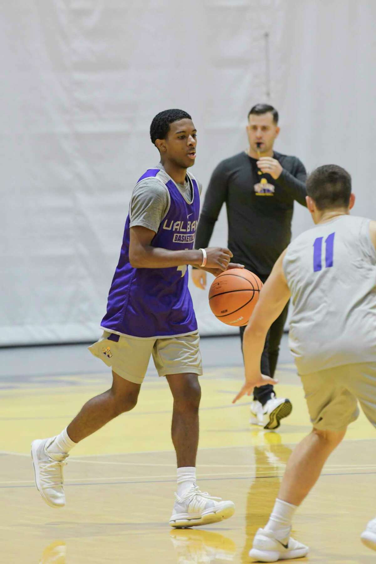 University at Albany men's basketball player, Reece Brooks, left, runs through drills with teammates during practice on Thursday, Oct. 11, 2018, in Albany, N.Y. (Paul Buckowski/Times Union)