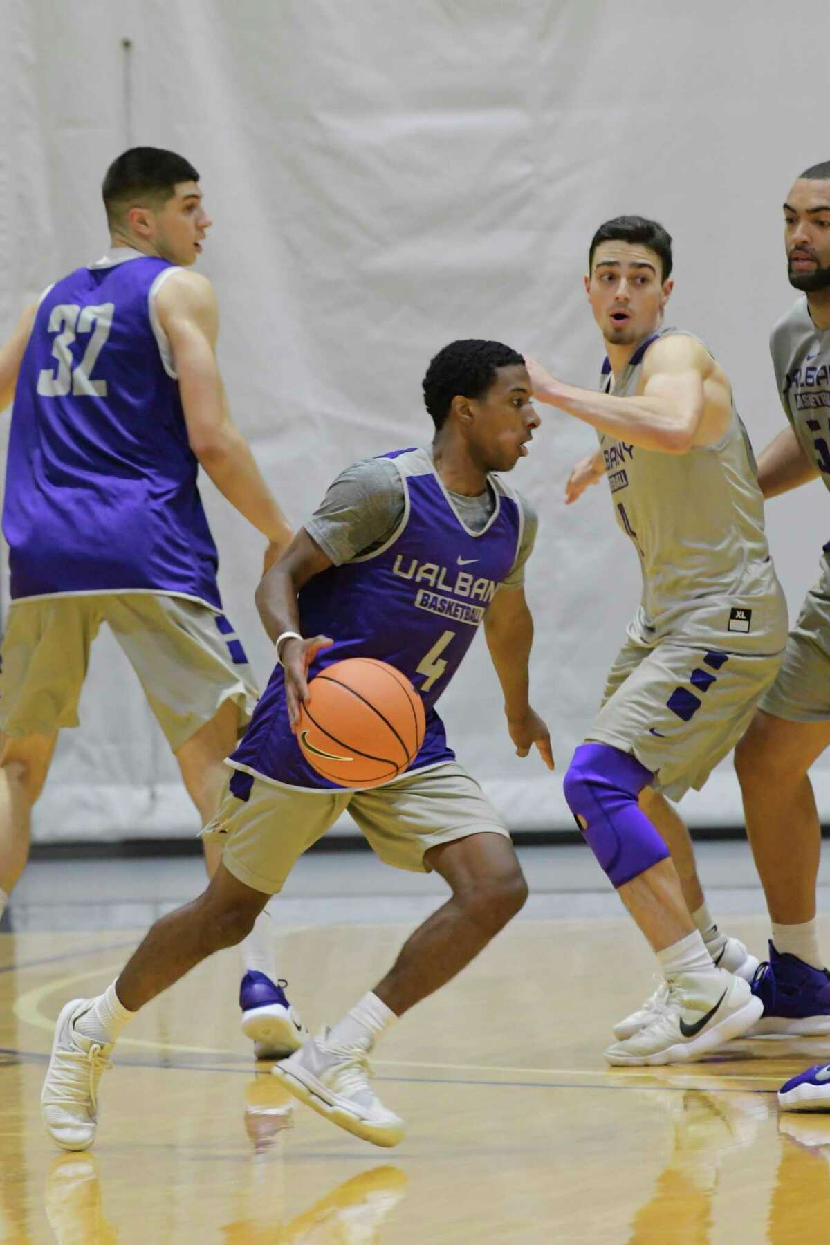 University at Albany men's basketball player, Reece Brooks, left, runs through drills with teammates during practice on Thursday, Oct. 11, 2018, in Albany, N.Y. (Paul Buckowski/Times Union)