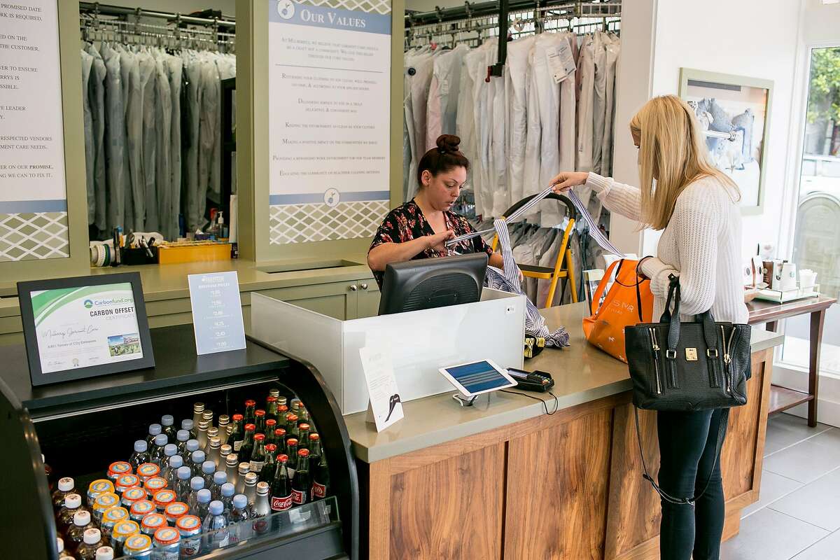Nolina Luna, left, helps a customer at Mulberrys Garment Care in the Marina on Thursday, Oct. 11, 2018 in San Francisco, Calif. Mulberrys, a Minnesota dry cleaning company, is buying Laundry Locker making it the largest laundry company in Northern California.