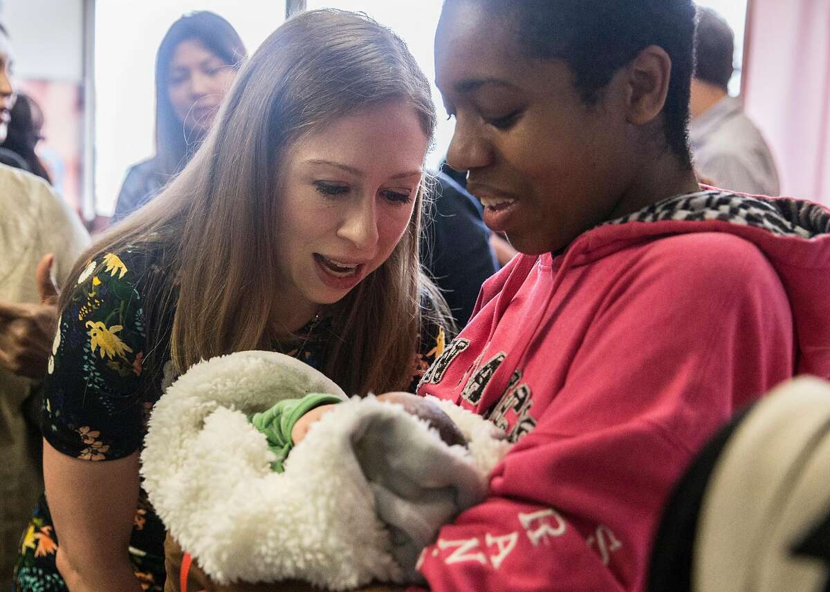Chelsea Clinton greets Dominica Thomas and her 4-day-old son, Lance, during a tour of the birth center and children's health clinic at Zuckerberg San Francisco General Hospital in San Francisco, Calif. Thursday, Oct. 11, 2018.