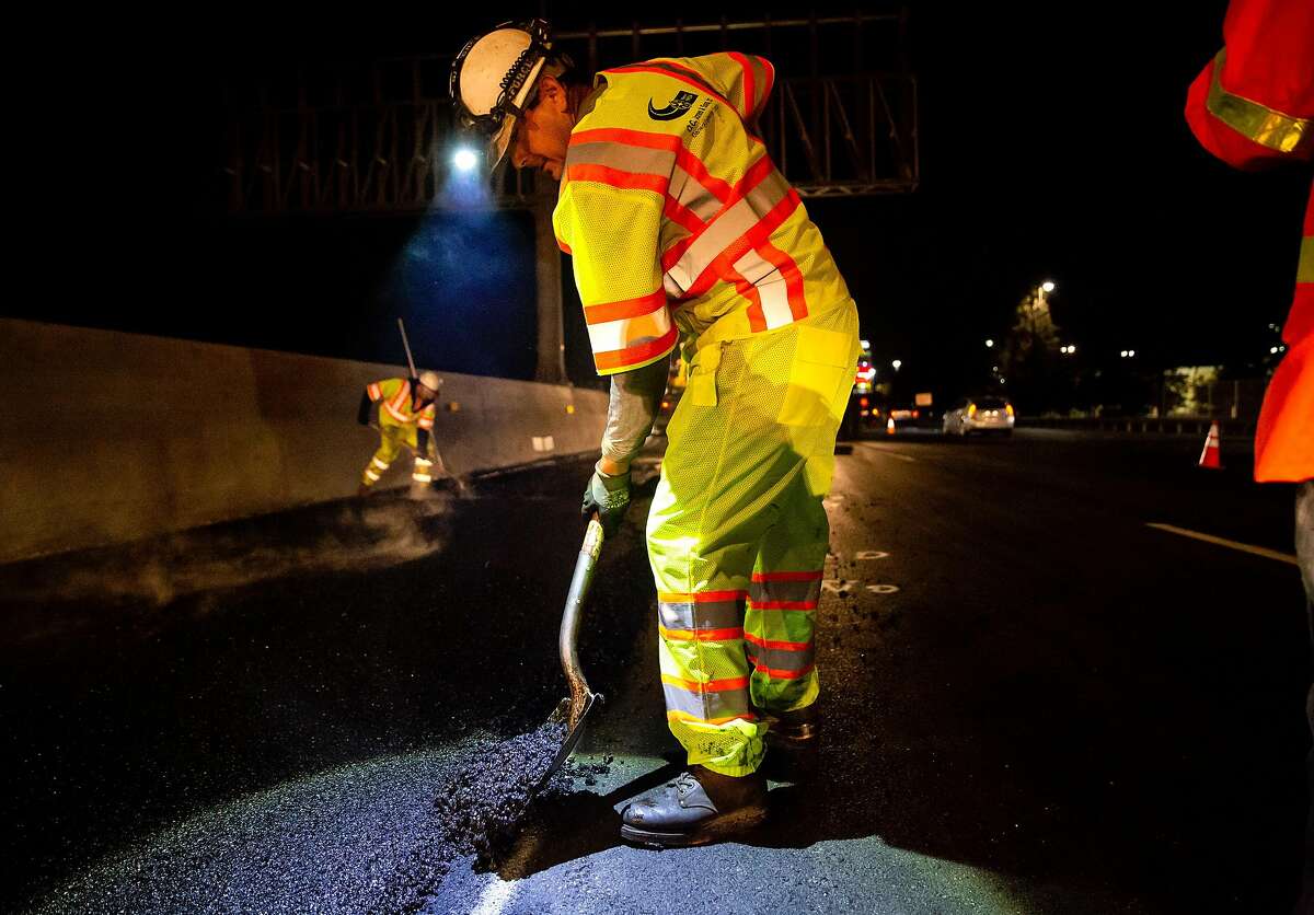 O.C. Jones and Sons contractors working with CalTrans pave rubberized hot-mix asphalt on two of the Southbound lanes of the I-880 freeway in Hayward, Calif. on Wednesday, Oct. 9, 2018.