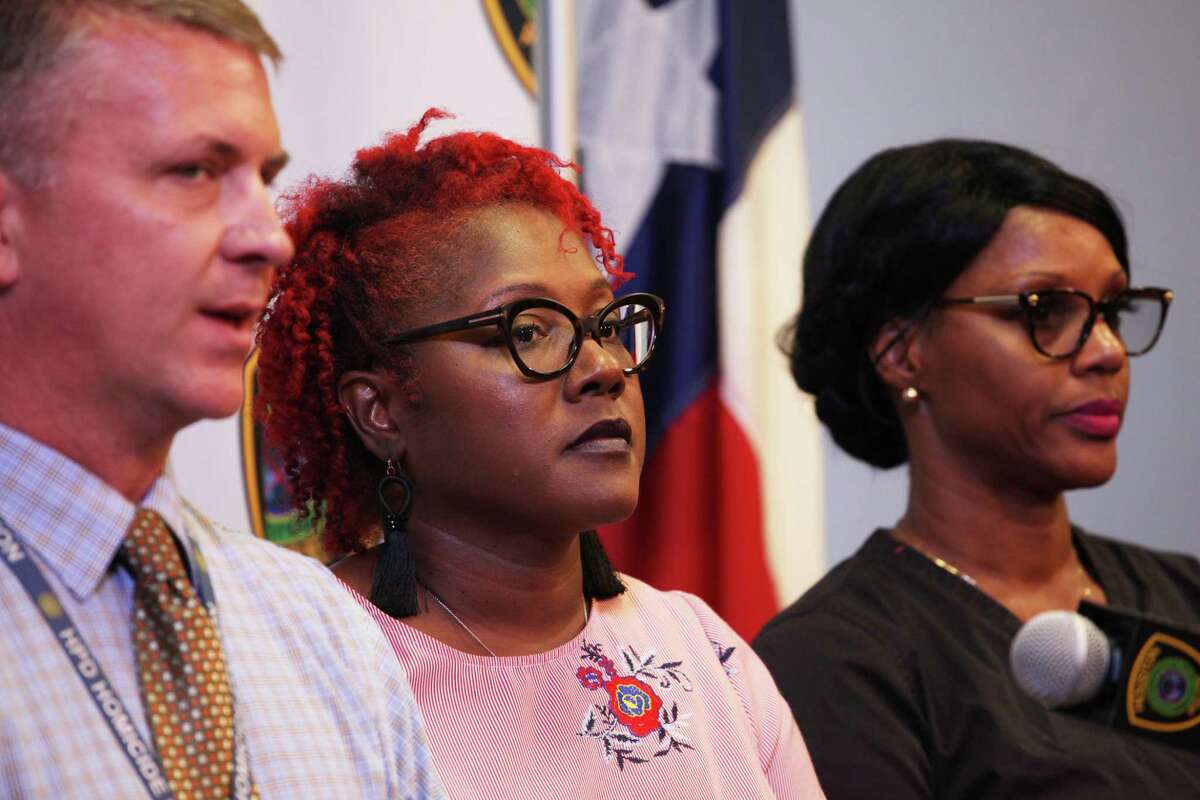 Nicole Thomas, center, stands alongside a Houston police Det. Mark Condon, left, to ask for tips on Oct. 11, 2019, on an Aug. 11 shooting that killed her daughter, Jade Walker.