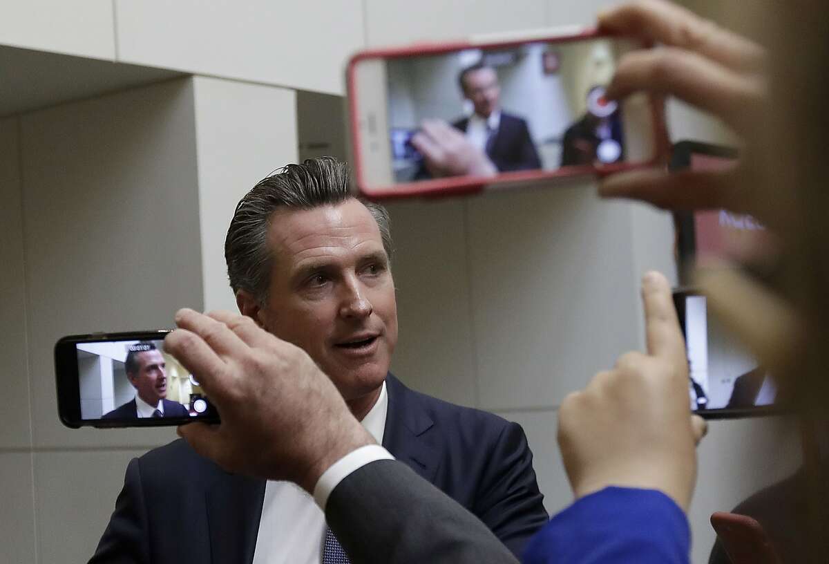 Democratic candidate Gavin Newsom speaks with reporters after a California gubernatorial debate with Republican candidate John Cox at KQED Public Radio Studio in San Francisco, Monday, Oct. 8, 2018. (AP Photo/Jeff Chiu, Pool)