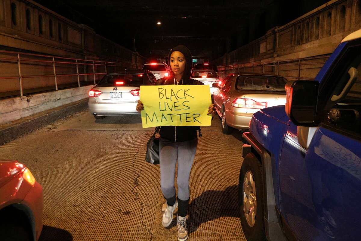 A protester marches through stopped cars while in the Alameda-Oakland tunnel during a "Millions March" demonstration in Oakland protesting the killing of unarmed black men by police in this Dec. 13, 2014 photo. A new study out of UC Berkeley found that less-educated black women who report high levels of racial discrimination may face higher risk of developing chronic diseases.