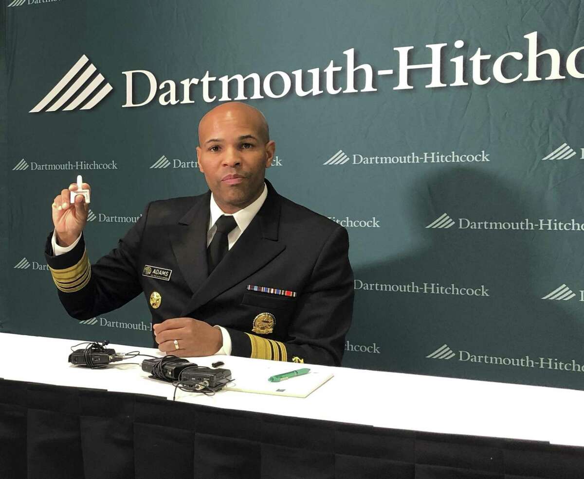 U.S. Surgeon General Jerome Adams holds up a nasal spray dose of naloxone, an opioid overdose reversing drug in Concord, N.H., on Friday, Oct. 5, 2018. Adams was the keynote speaker at a conference organized by Dartmouth-Hitchcock Medical Center about the affects of the opioid crisis on children and families. (AP Photo/Holly Ramer)