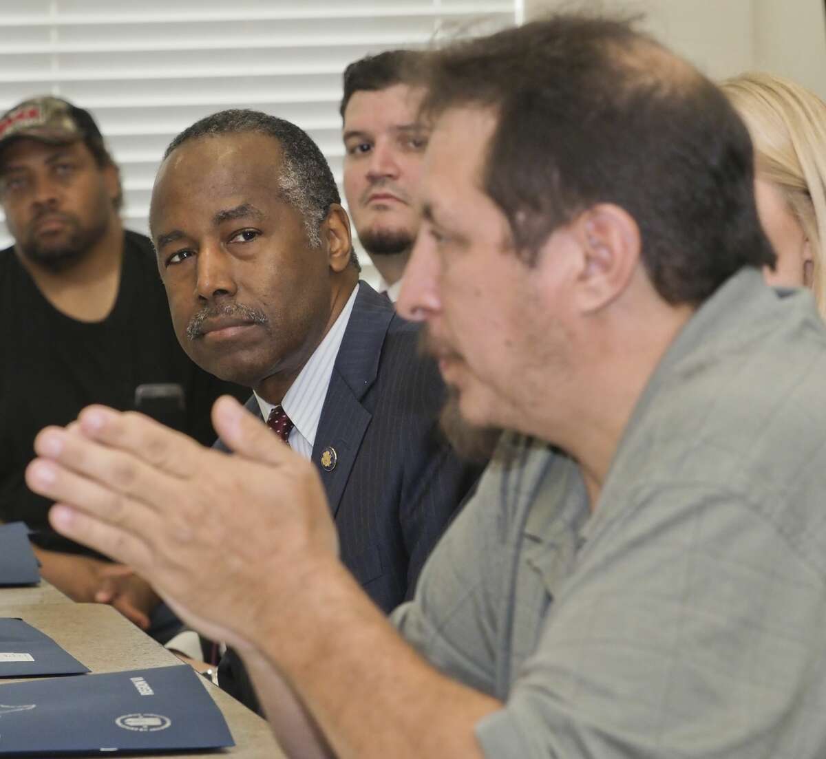 HUD Secretary Ben Carson listens as veteran Edward Cano speaks 10/12/18 about his experience utilizing housing vouchers and veteran services during a roundtable discussion with Carson, other area veterans and members of the Midland Housing Authority. Tim Fischer/Reporter-Telegram