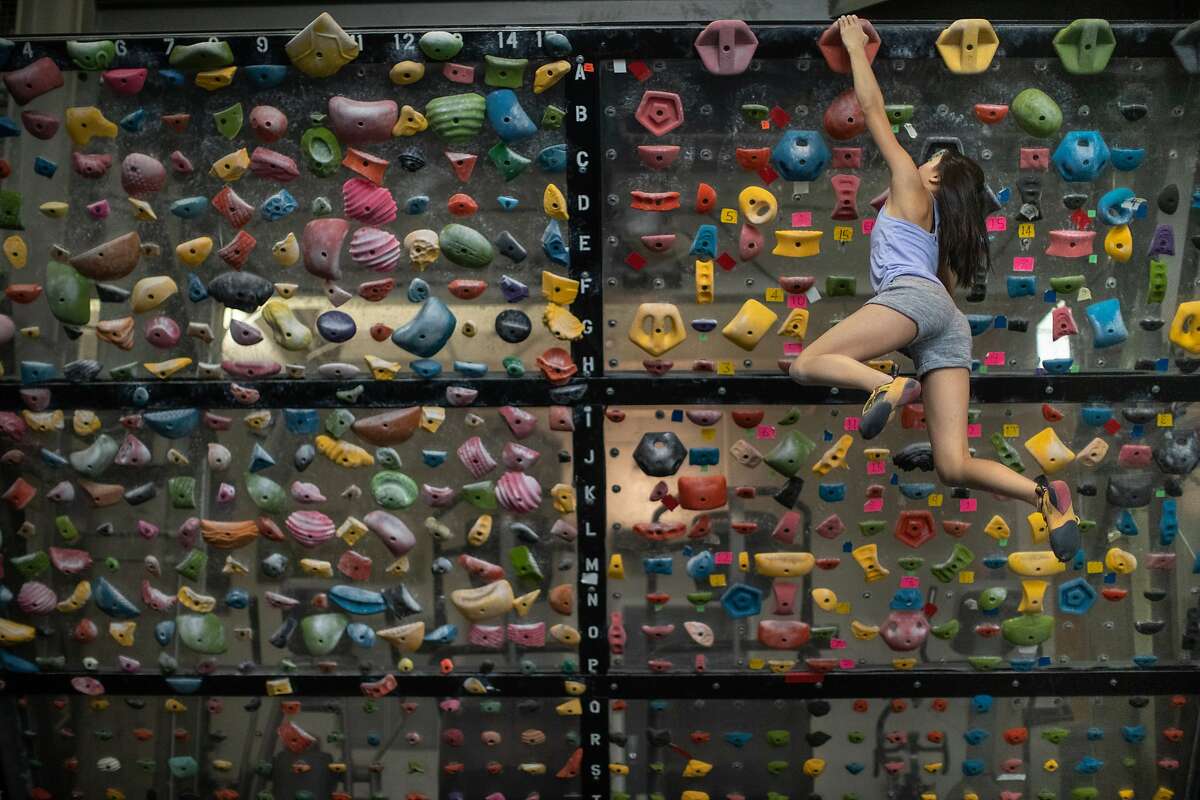 Abbie Cheng, 13, climbs a wall at Planet Granite on Thursday, Sept. 27, 2018, in San Francisco, CA. San Francisco advances to California’s least-restrictive tier for reopening, expanding access to indoor climbing gyms, movie theaters, houses of worship and more.