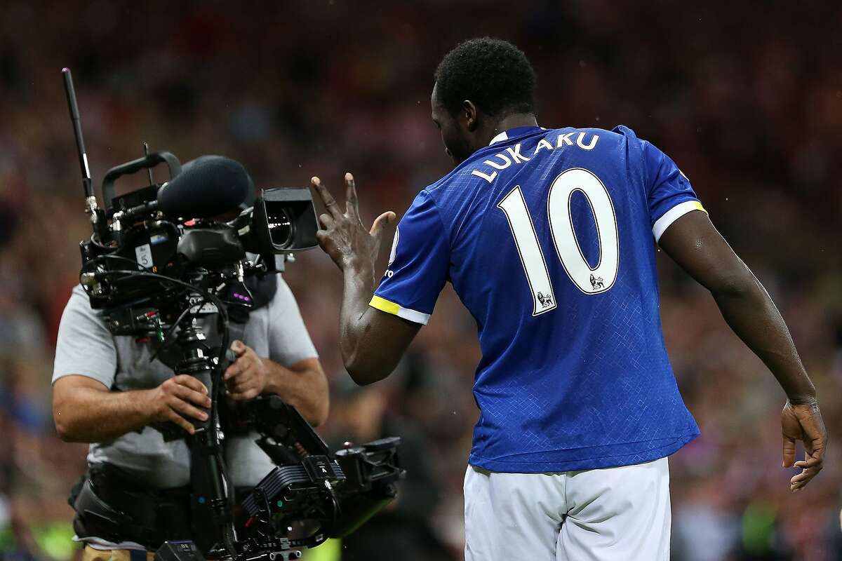 (FILES) In this file photo taken on September 12, 2016 Everton's Belgian striker Romelu Lukaku gestures into the lens of a television (TV) camera as he celebrates scoring his team's third goal during the English Premier League football match between Sunderland and Everton at the Stadium of Light in Sunderland, north-east England. - Piracy poses an existential problem for broadcast rights holders but there are no signs that live sport is losing its glittering allure, according to Eleven Sports chief executive Marc Watson. The company -- a relative upstart in a cut-throat field -- has got its hands on a number of high-profile events this year, adding the UK and Irish rights to the PGA Championship, La Liga and Serie A to a growing portfolio. (Photo by SCOTT HEPPELL / AFP) / RESTRICTED TO EDITORIAL USE. No use with unauthorized audio, video, data, fixture lists, club/league logos or 'live' services. Online in-match use limited to 75 images, no video emulation. No use in betting, games or single club/league/player publications. TO GO WITH AFP STORY BY Pirate Irwin / SCOTT HEPPELL/AFP/Getty Images