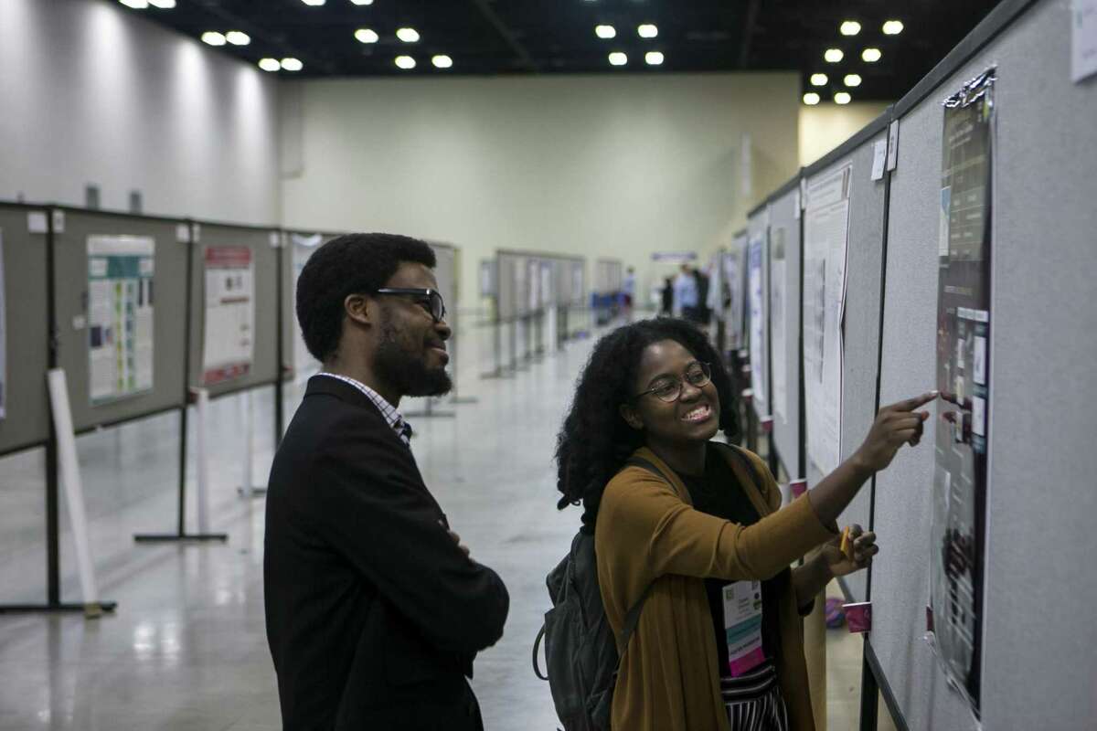 Omase Omoruyi shares her research on star formation with Chukwunoso Arinze on Friday during the 45th annual National Diversity in STEM Conference. The conference was sponsored by the Society for the Advancement of Chicanos/Hispanic & Native Americans in Science at the Henry B. Gonzalez Convention Center.