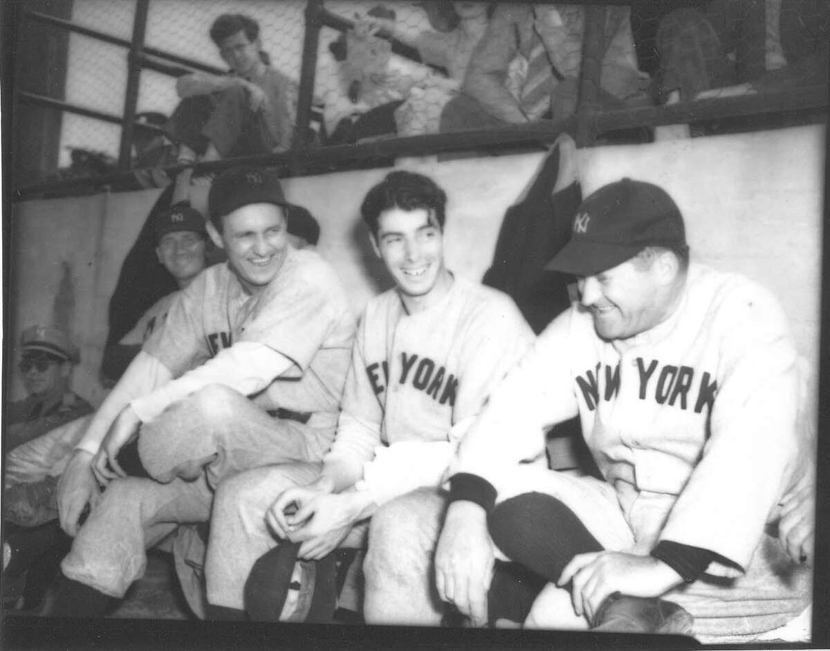 New York Yankees players Lefty Gomez (from left) and Joe DiMaggio have a laugh on the bench with manager Joe McCarthy during their game against the San Antonio Missions at Tech field in San Antonio in April 1940.