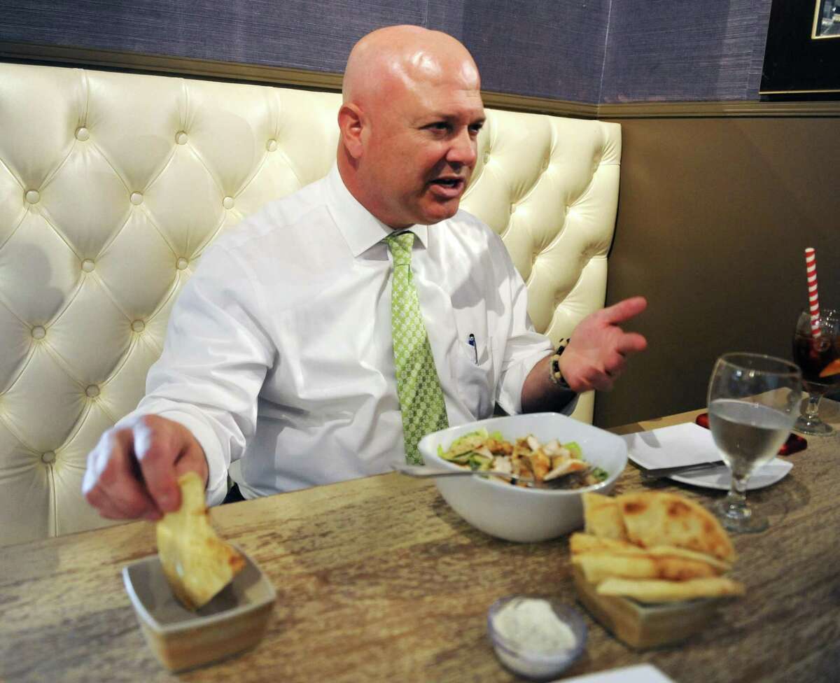 State Rep. Mike Bocchino, R-Greenwich, uses a pita to demonstrate where funds for a lockbox are distributed during lunch at Famous Greek Kitchen in the Byram section of Greenwich, Conn. Wednesday, Oct. 3, 2018. Bocchino has been representing Connecticut's 150th District since 2015 and is up for re-election against Democrat Steve Meskers.