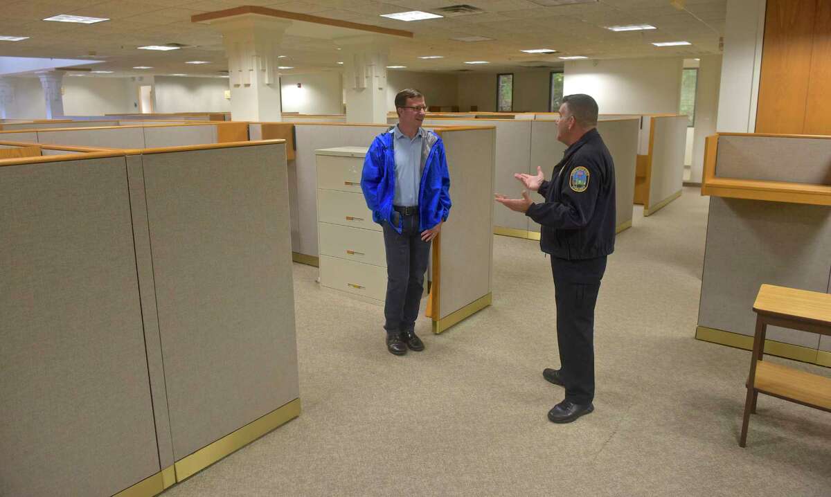 Newtown Police Chief James Viadero talks with Chairman of the Police Commission Joel Faxon during the department's tour of the old Tauton Press building, 191 South Main Street, which the town hopes to convert into a new police headquarters. Saturday, October 13, 2018, in Newtown, Conn.