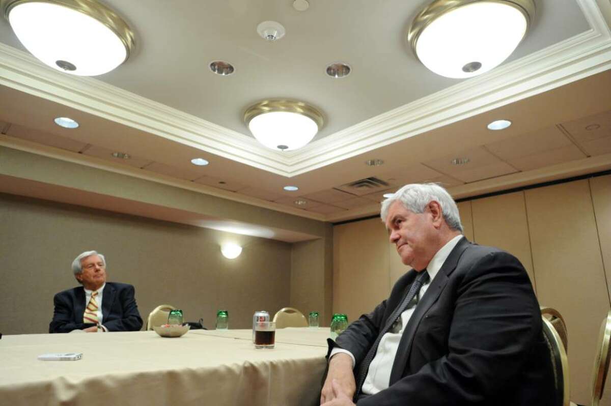 Former Speaker of the House Newt Gingrich sits with political consultant Joe Gaylord as he prepares for a Town Hall meeting bringing his citizen-action group American Solutions to the Stamford Marriott Wednesday, July 14, 2010. American Solutions is a citizen action network aimed at resolving the problems facing America today. Gingrich led a Town Hall meeting focused on topics including jobs and healthcare.