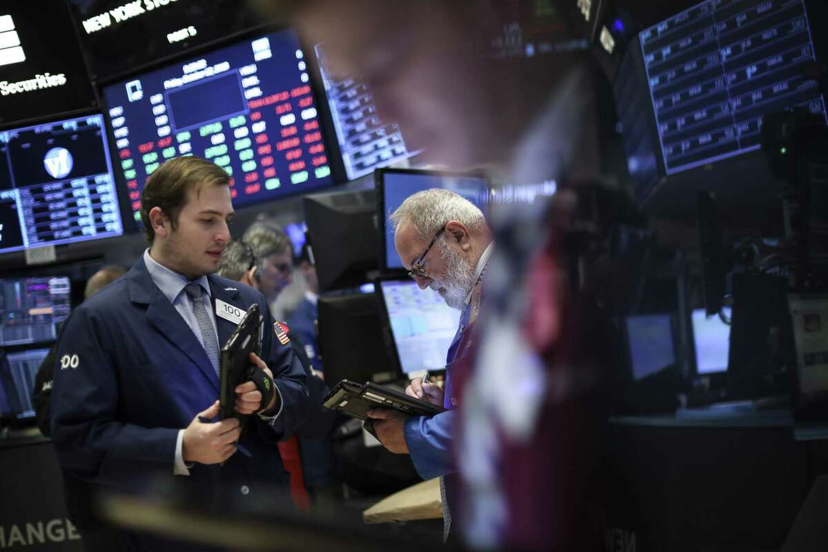 Traders and financial professionals work at the opening bell on the floor of the New York Stock Exchange (NYSE), October 12, 2018 in New York City. The Dow Jones Industrial Average jumped over 400 points at Friday's open, following two days of steep losses. (Photo by Drew Angerer/Getty Images)