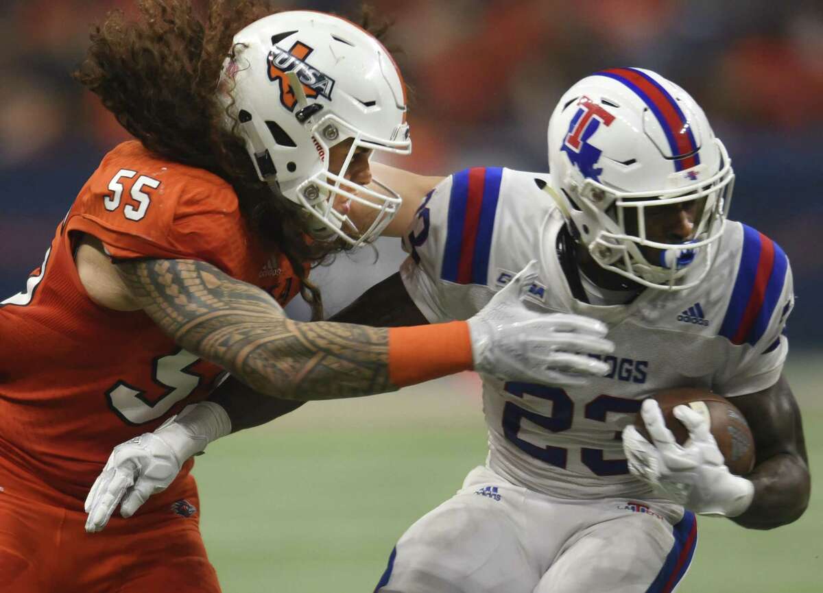 UTSA linebacker Josiah Tauaefa defends as Jaqwis Dance of Louisiana Tech runs for yardage during college football action in the Alamodome on Saturday, Oct. 13, 2018.
