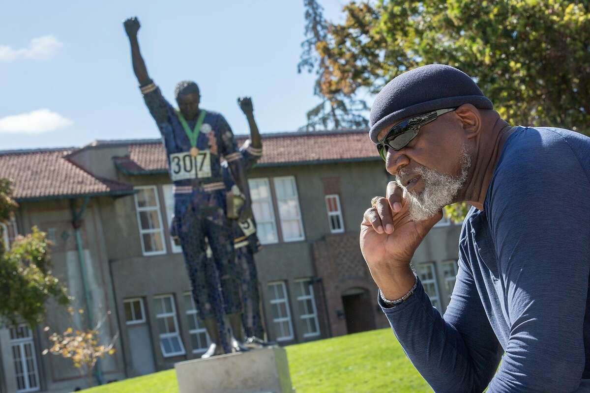 Harry Edwards sits for a portrait with the Olympic Black Power Statue at San Jose State University on Wednesday, Oct. 10, 2018, in San Jose, Calif.
