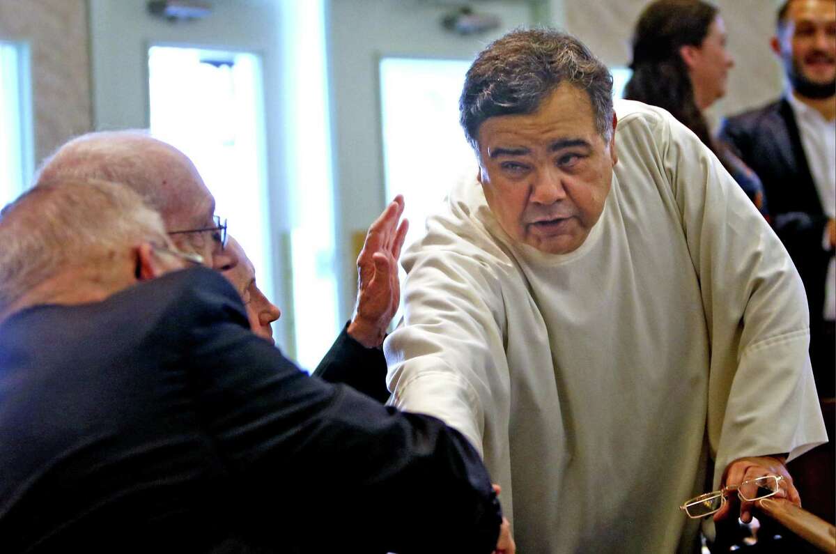 Father Oscar Vasquez greets members of the congregation before the mass. The new provincial, or leader of the Marianist order in the U.S., will spend time with his brothers and fellow priests on Saturday afternoon, and will preside over a Mass of Perpetual Profession, in which two men will profess their vows on Saturday, October 6, 2018 at Holy Rosary Catholic Church