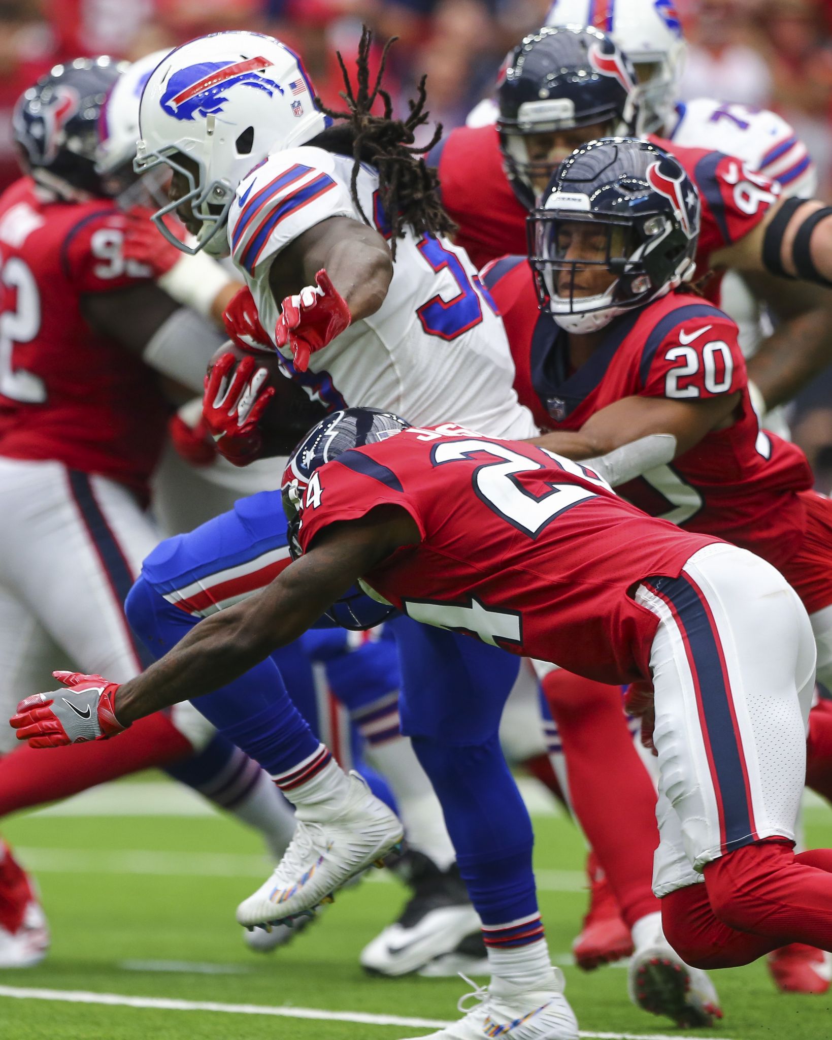 Houston, TX, USA. 14th Oct, 2018. Buffalo Bills running back Chris Ivory  (33) gets tackled as Houston Texans linebacker Jadeveon Clowney (90) pulls  him down by his hair during the 4th quarter