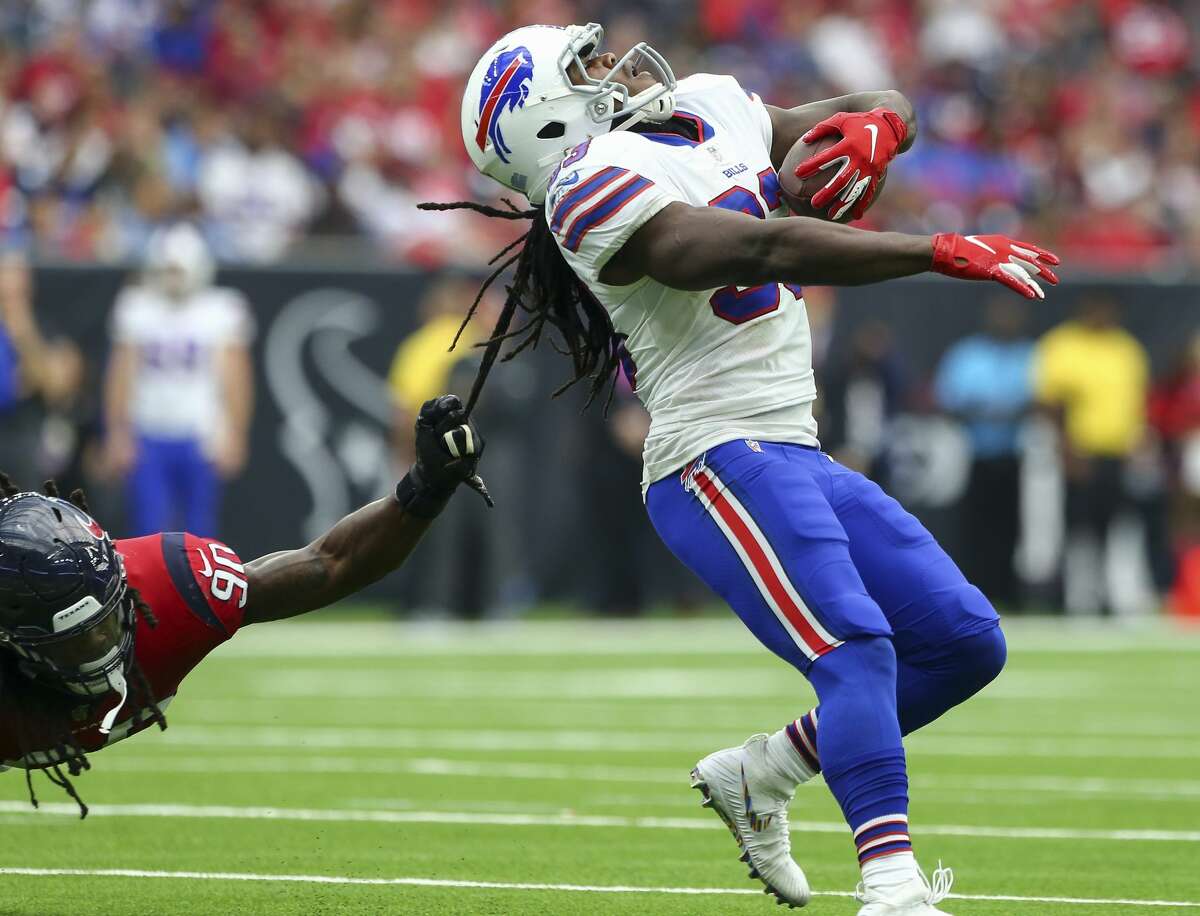 Houston Texans linebacker Jadeveon Clowney (90) tackles Buffalo Bills running back Chris Ivory (33) by the dreadlocks during the fourth quarter of an NFL game at NRG Stadium Sunday, Oct. 14, 2018, in Houston. The Texans won 20-13.