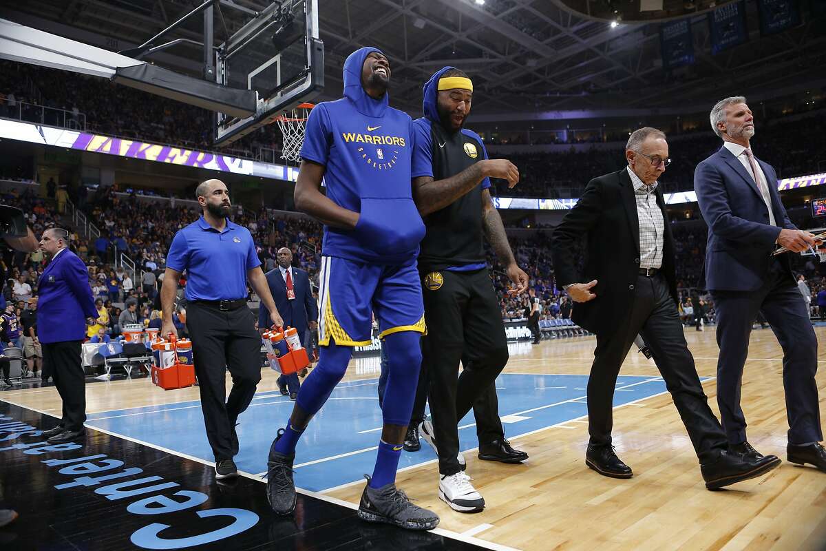 From left: Golden State Warriors forward Kevin Durant (35) and center DeMarcus Cousins (0) during the second half of an NBA preseason game at SAP Center on Friday, Oct. 12, 2018, in San Jose, Calif.