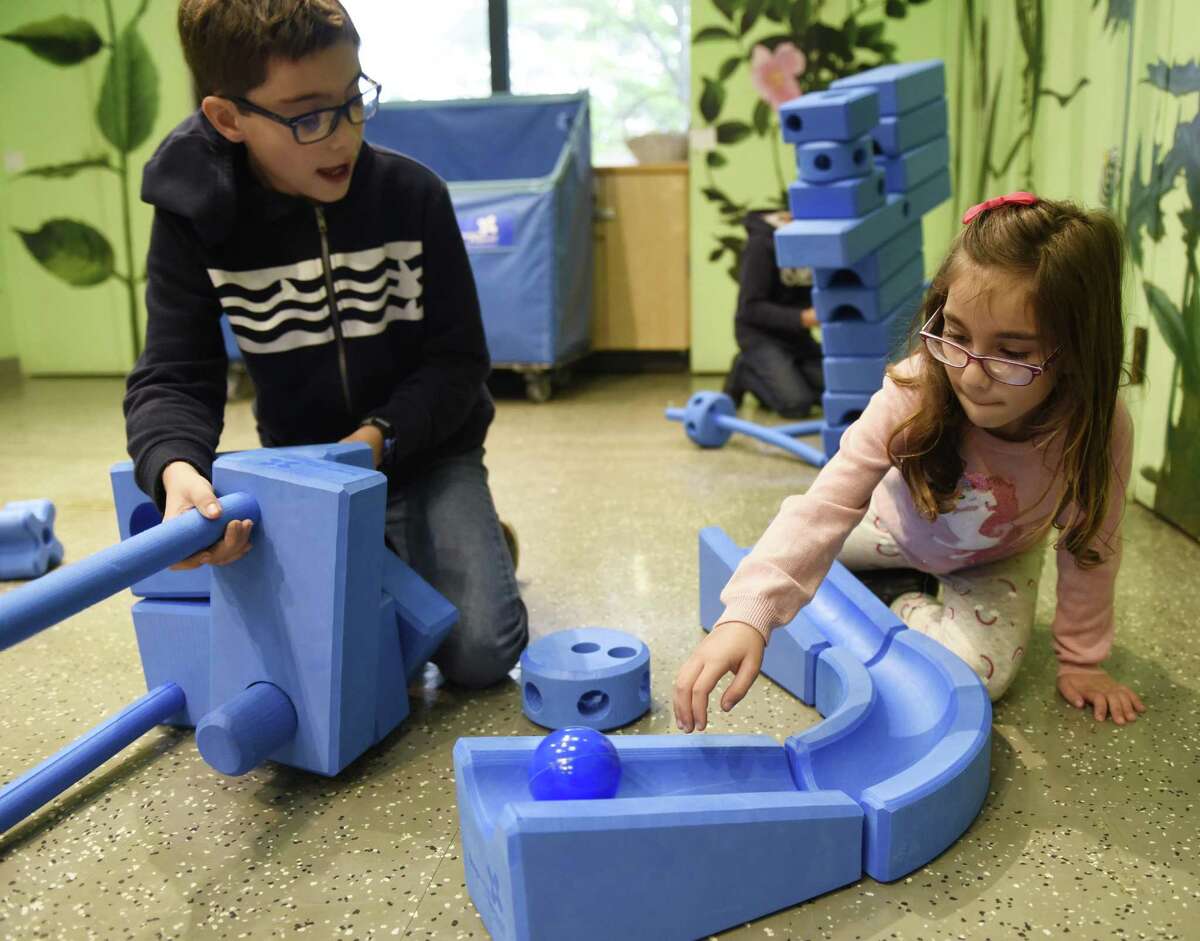 Norwalk's William McLaughlin, 11, and Molly McLaughlin, 6, play with Imagination Playground blocks during Fall Family Day at the Bruce Museum in Greenwich, Conn. Sunday, Oct. 14, 2018. Students used the lightweight foam blocks to build their own imaginary objects and also completed specific challenges to build the blocks into a tower, flower, car and more. The afternoon included engineering programs presented by The Children's Museum of West Hartford.