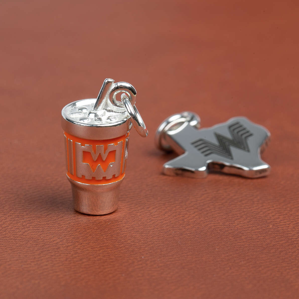 Whataburger and James Avery fans can show everyone that their cups runneth over with love for the two brands via a brand-new sterling silver charm. The Texas companies teamed up to create a one-of-a-kind collector's item, a tiny replica of the Whataburger cup, complete with hand-painted orange enamel.