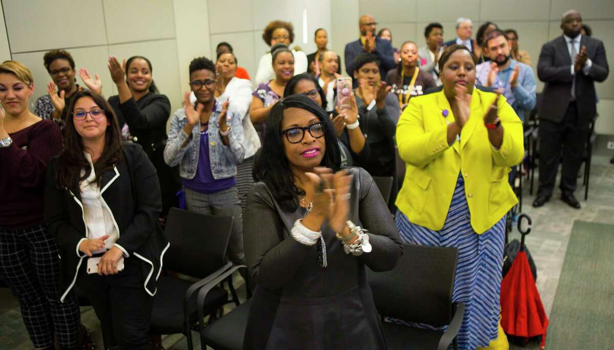 People filling the boardroom applaud for interim superintendent Grenita Lathan during a press conference at the Hattie Mae White Educational Support Center, Monday, Oct. 15, 2018 in Houston. Trustees apologized for the recent turmoil among the school board and stated that Lathan would continue to serve as the interim superintendent.