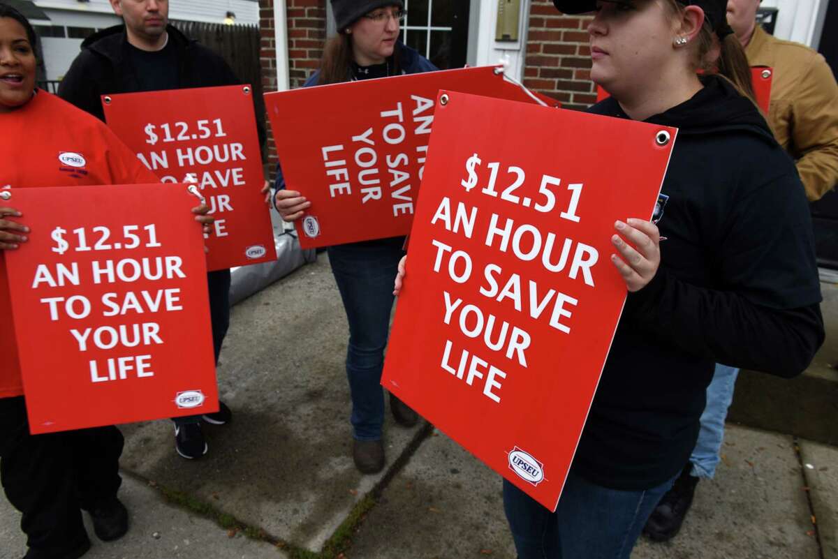 Roni Weeks, right, joined fellow Mohawk Ambulance Service workers in asking for better pay and working conditions from the local ambulance company on Monday, Oct. 15, 2018, near the Mohawk offices on Central Avenue in Albany, N.Y. The emergency medical staffers are represented by the United Professional Services Employees Union. Their contract expired in April. (Will Waldron/Times Union)