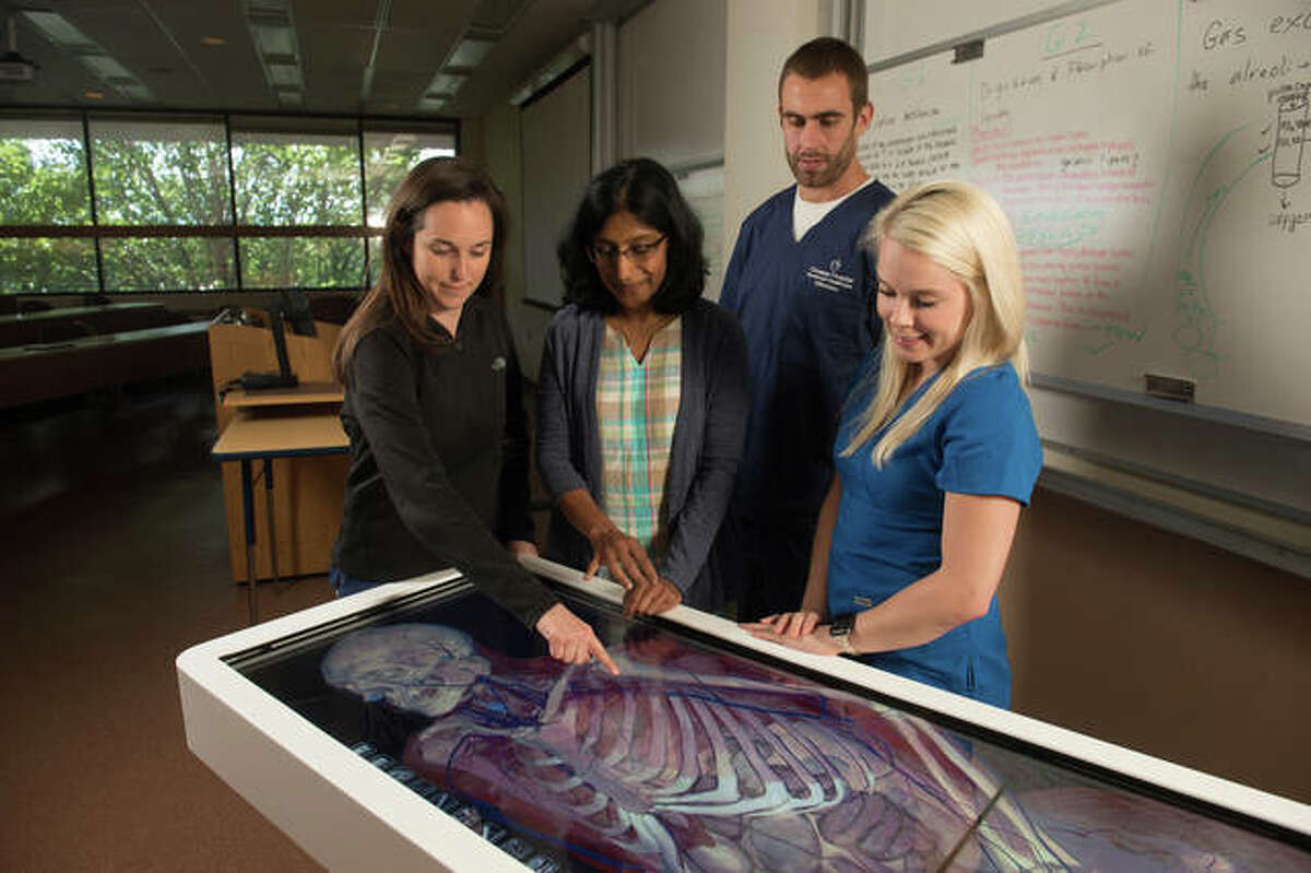 SIUE School of Nursing students use the Anatomage Table under the direction of Dr. Chaya Gopalan (middle) to explore various anatomical structures and their interplay.