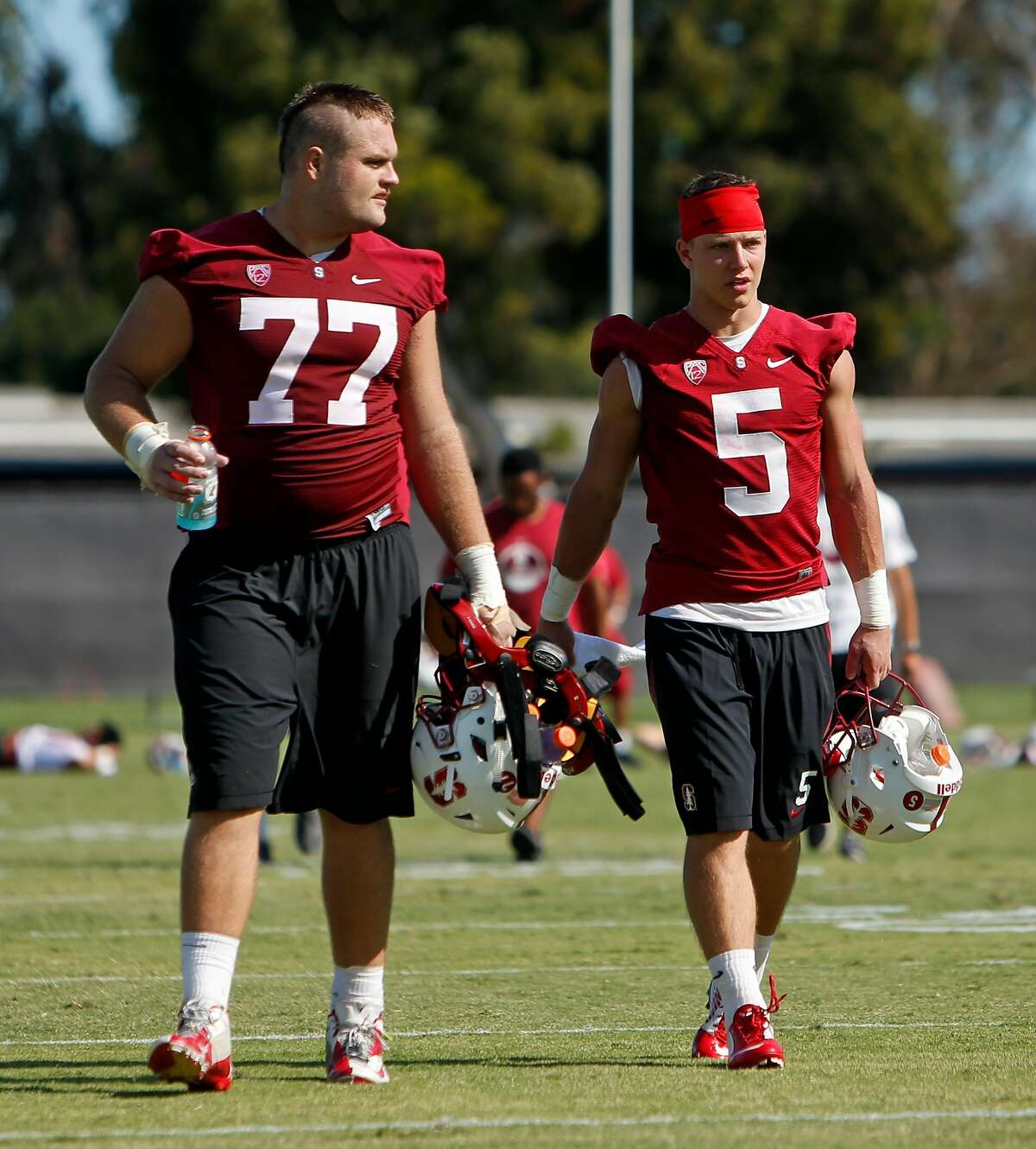 Stanford running back Christian McCaffrey (5) with offensive lineman Casey Tucker after practice in Stanford, Calif., on Monday, Aug. 10, 2015.