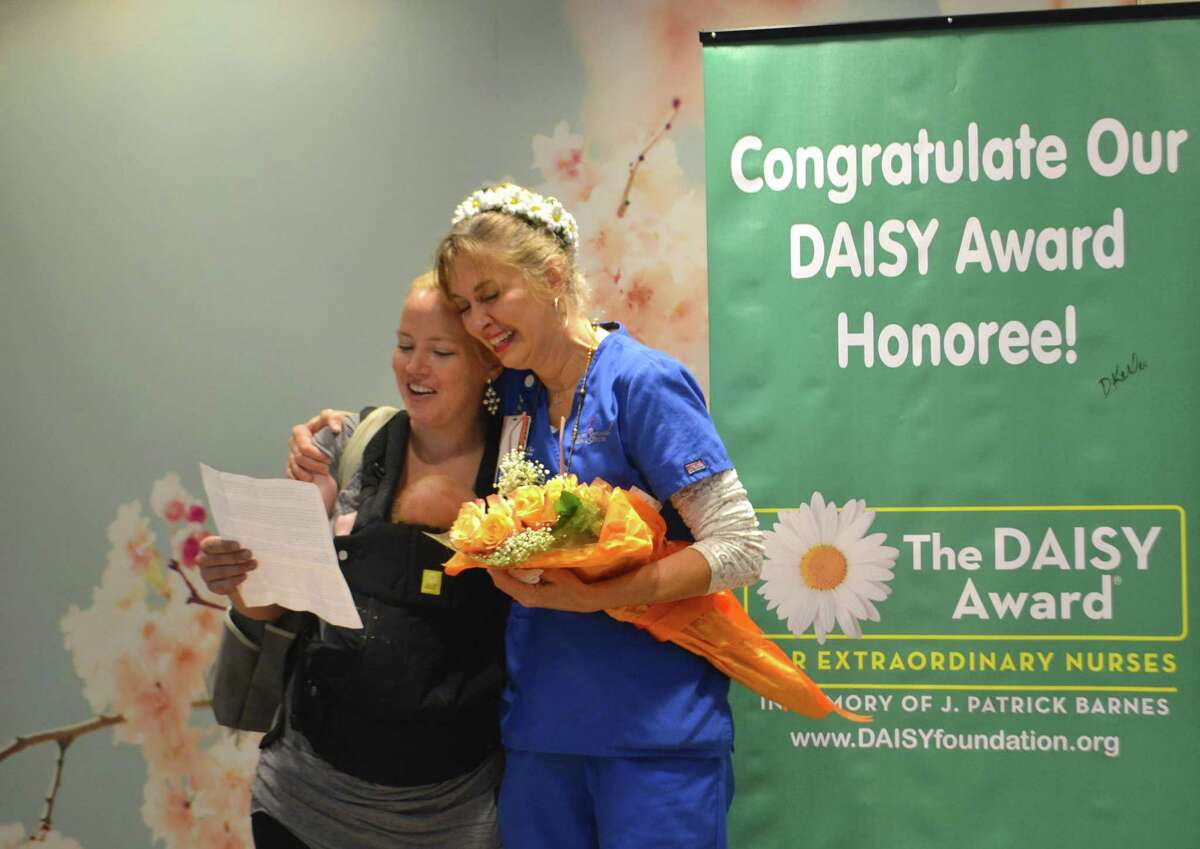 CRMC patient Jessica is pictured with her baby and CRMC Labor and Delivery nurse Karen Jones when Jones was awarded The DAISY Award for the month of August. Jones assisted Jessica with her birth and Jessica nominated her for the new DAISY Award which recognizes exceptional nursing.