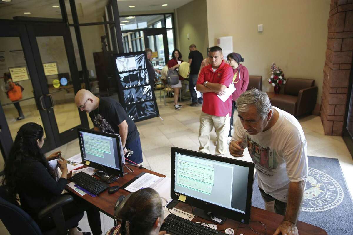 Juan Peña, 79, lower right, inquires about his voter registration status at the Bexar County Elections Department, Tuesday, Oct. 9, 2018. Tuesday was the deadline to register in order to vote in the upcoming November 6 general election. Officials said the department had a steady flow of people registering or changing their address in the days leading up to the deadline but on Tuesday there was a marked increase.
