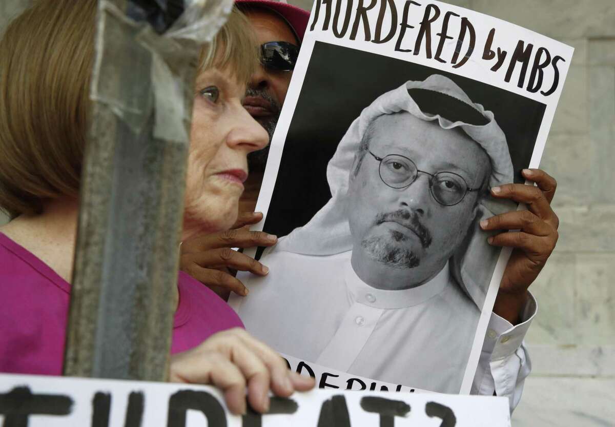 People hold signs during a protest on Oct. 10, 2018 at the Saudi Arabia embassy in Washington D.C., about the disappearance of Saudi journalist Jamal Khashoggi.