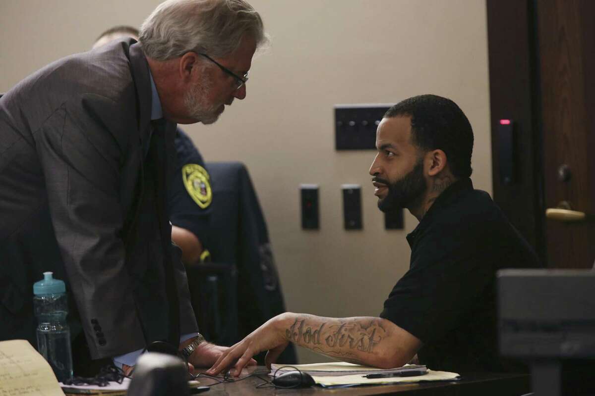 Xavier DeShawn Johnson, right, talks with one of his attorneys, Ed Shaughnessy, on the first day of his murder trial in the Bexar County 187th Criminal District Court, Tuesday, Oct. 16, 2018. Johnson is accused of fatally shooting Christopher Dotson at a house on the 1200 block of Center Street on June 2016.