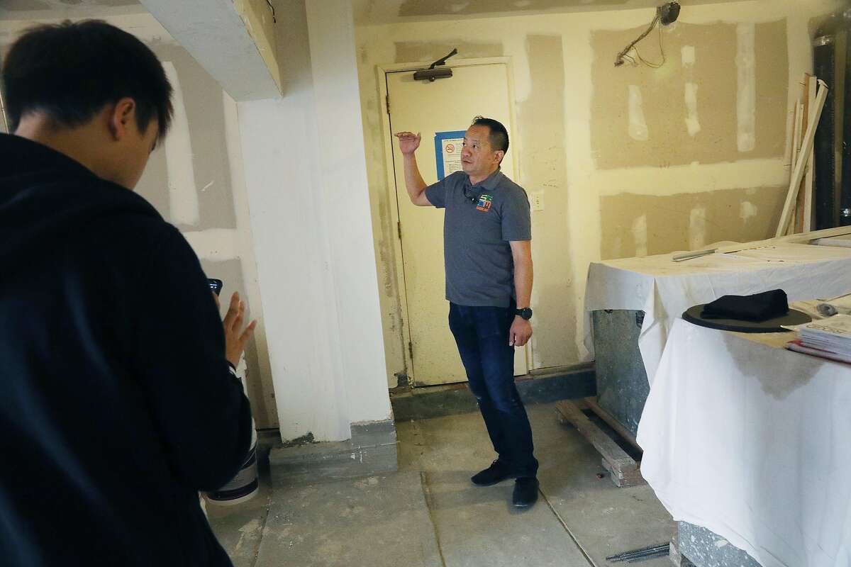 George Mak, SGDM director, stands next to a strong wall (directly at left of Mak) at a building that is being seismically retrofitted on Tuesday, October 16, 2018 in San Francisco, Calif.