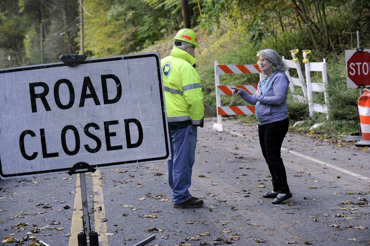 Terri Hahn, right, president of Timber Trails, talks with a DOT inspector Friday morning. Route 37 in Sherman, just north of Big Trail near the New Fairfield town line, was closed Sept. 6 to repair the washed out road from all of the rain this summer.