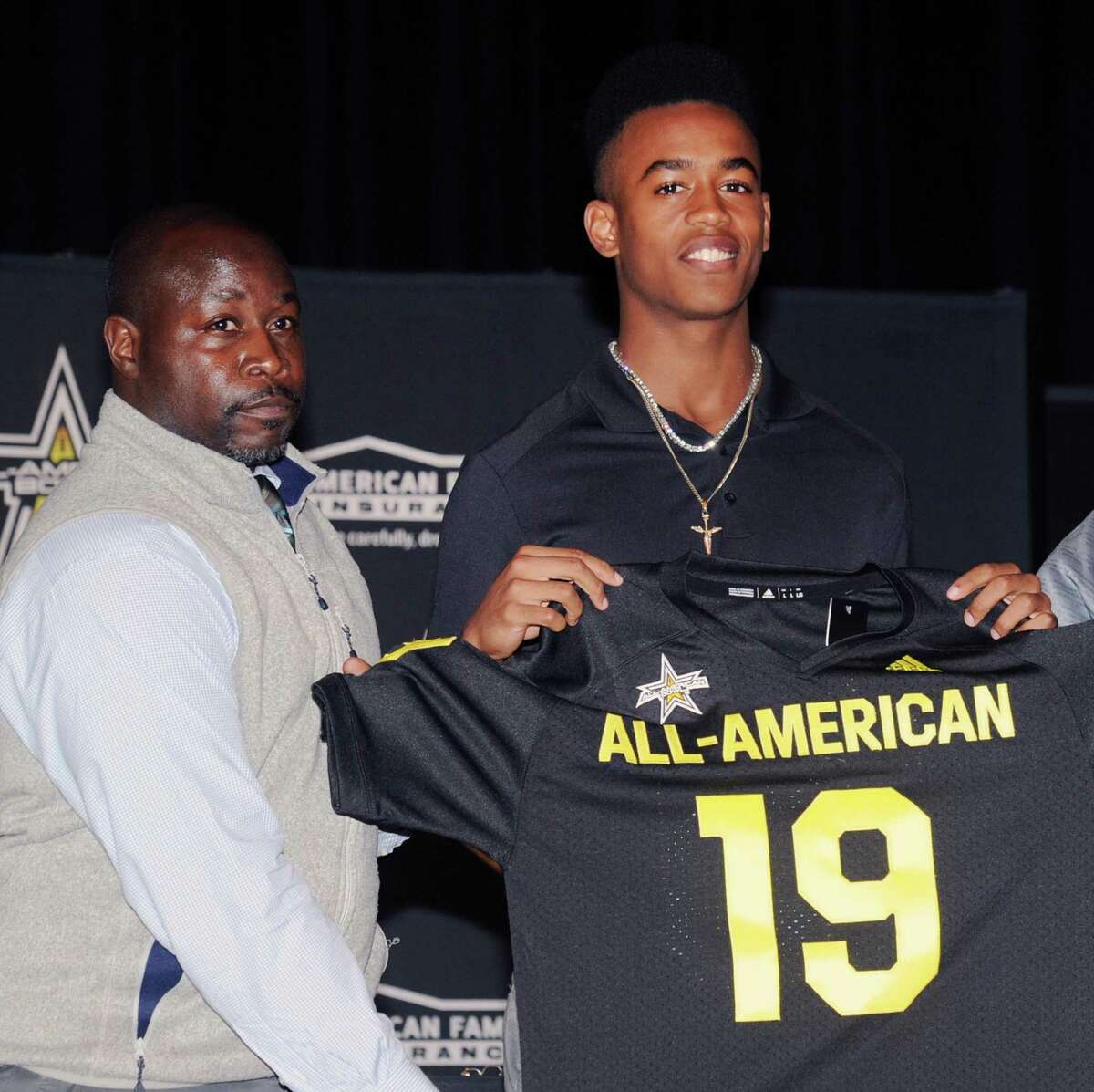Brunswick School football player, Cornelius Johnson, right, a wide receiver, with his football coach, Jarrett Shine, during the presentation of Johnson's All-American football jersey from the organizers of the national All-American Bowl by American Family Insurance at Brunswick School where Johnson plays and is a senior at the school, Greenwich, Conn., Tuesday, Oct. 16, 2018. The bowl game will be played in San Antonio on January 5, 2019.