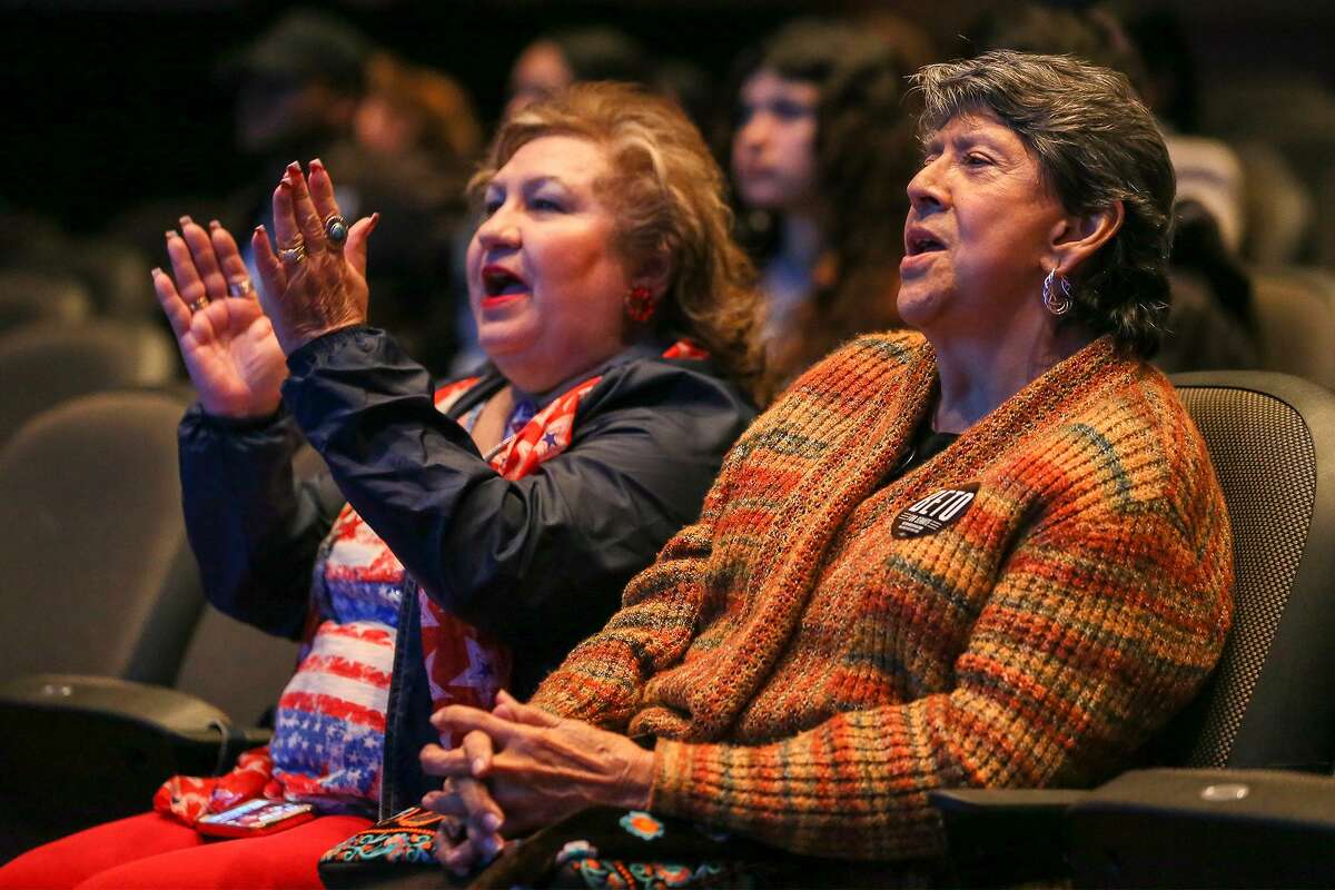O'Rourke supporters Elia Garcia (right) and Della Jimenez watch the televised debate between Senate candidates Ted Cruz and Beto O'Rourke from their seats in the Palo Alto College Performing Arts Center on Tuesday, Oct. 16, 2018.