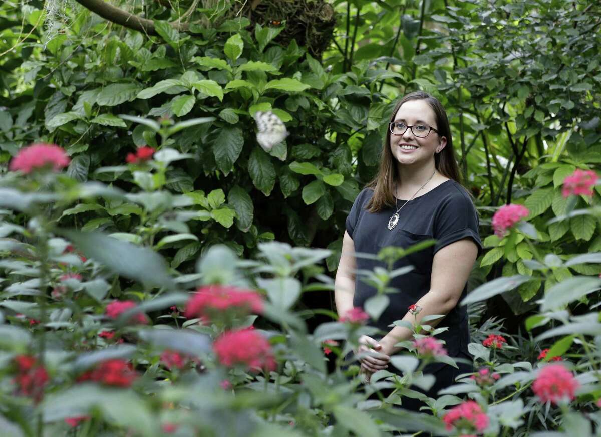 Poet Holly Walrath is shown in the Cockrell Butterfly Center in Houston.