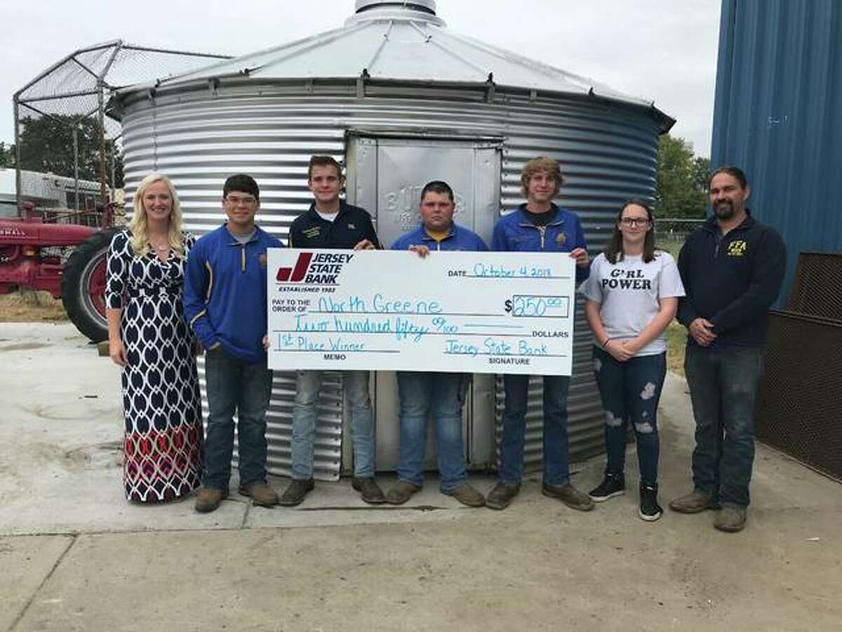 Members of the North Greene FFA chapter hold a check for $250 from Jersey State Bank. The chapter won first place in the bank’s social media contest, receiving 3,352 votes.