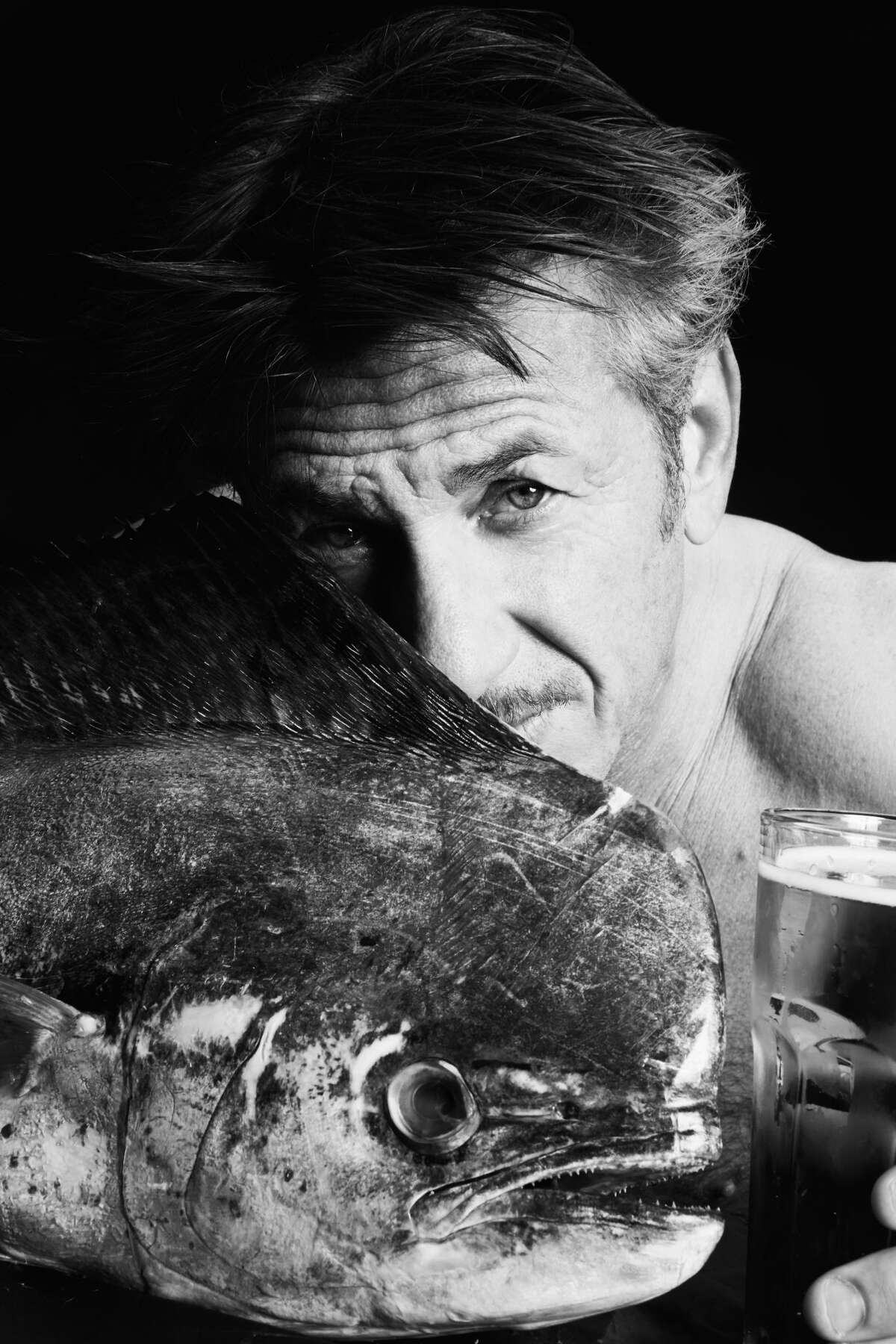 Sean Penn poses with mahi mahi as part of the Fishlove photo campaign to stem overfishing in European waters.