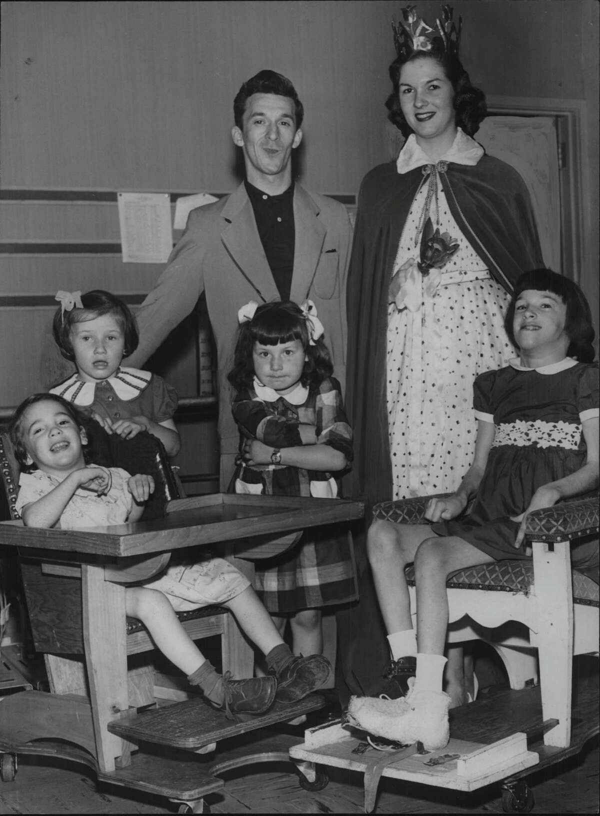 1953: Peggy A Retter, Albany Tulip Festival Queen 1953, visits children at the Albany Cerebral Palsy Treatment Center. She is shown in her regal attire with Patricia and Adele, seated, and Cynthia, Cathy and Louis Ramundo, standing. Mr. Ramundo, a former patient at the center, is producing and directing a benefit show, which will star Les Paul and Mary Ford and teen-age entertainers. June 3, 1953 (Knickerbocker News Staff Photo/Times Union Archive)