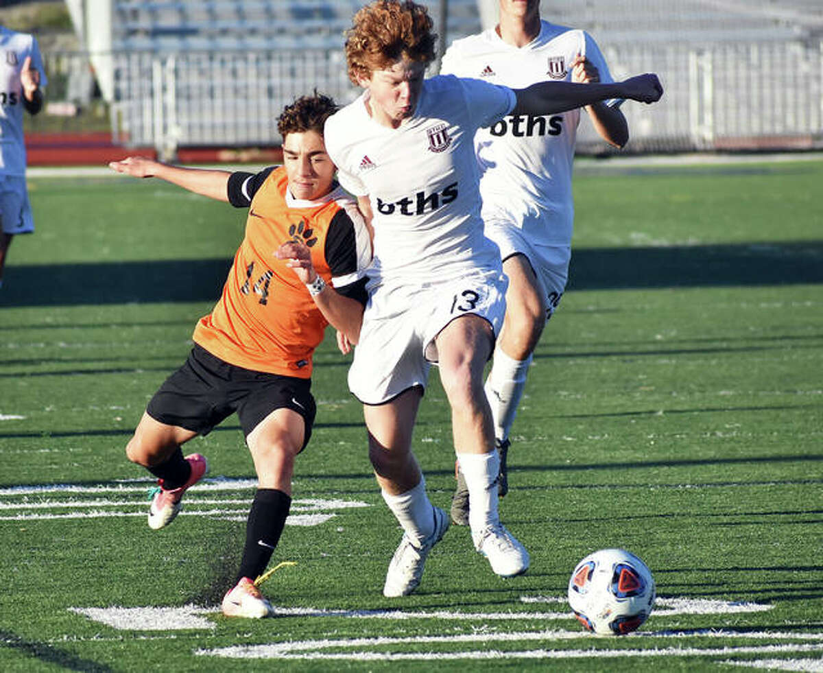 Edwardsville midfielder Jakob Doyle, left, battles for possession against a Belleville West player during the first half of Tuesday’s regional semifinal in O’Fallon.