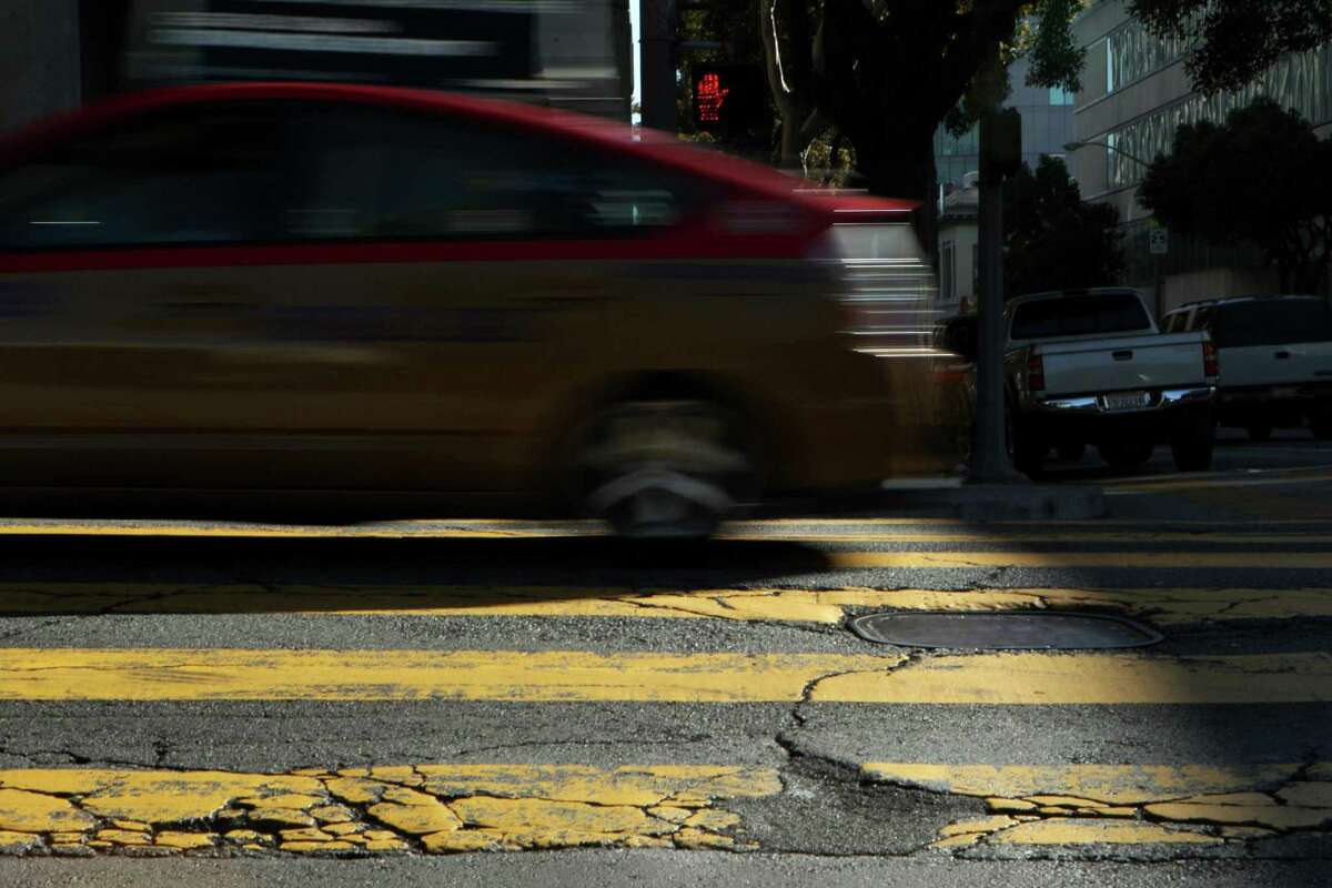 Drivers rattle along Franklin Street at Golden Gate Avenue in San Francisco. A report found that 71 percent of streets in San Francisco, Oakland and nearby cities are dilapidated.