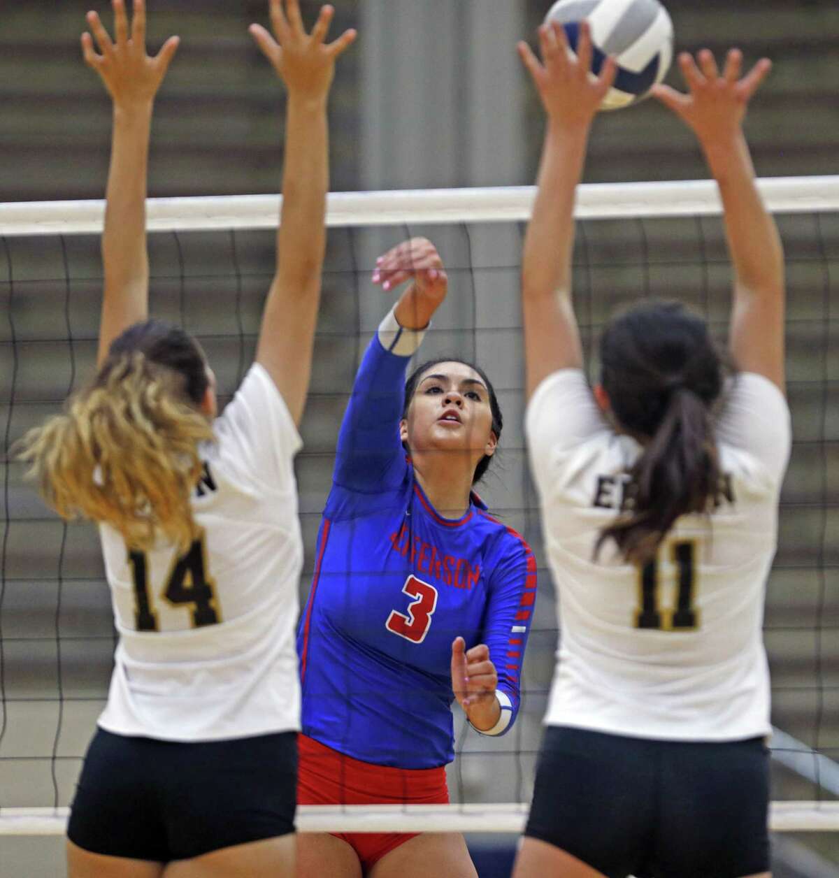 Jefferson's Noelia Rocha,C slams the ball past Edison's Natalie Esqueda,L and Bailey Barnes from the District 27-5A high school volleyball match between Jefferson and Edison on Tuesday, September 18, 2018 at Alamo Convocation Center.