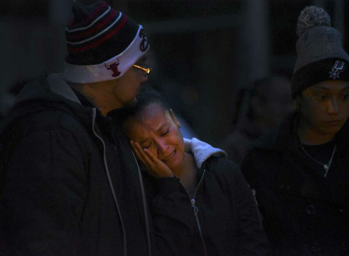 Patricia Slack, mother of Charles Roundtree, an 18-year-old who was shot and killed in the 200 block of Roberts Street, weeps during a gathering to memorialize him. Roundtree was unarmed and was hit by a bullet fired at another person.